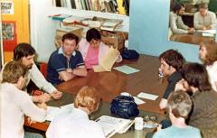 caption popup|Volunteers at a Checkpoint editorial meeting. On the left with his back to the camera is a young Kevin Brennan, now Cardiff West MP and then our Volunteer Organiser in one of his first paid jobs.