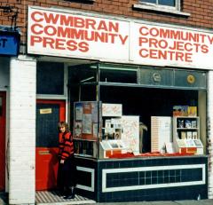 caption popup|The street-level face of Community Projects Centre and Cwmbran Community Press in 1988. Our famous Red Door led to a warren of rooms on three floors housing a second hand book shop, the Cwmbran Checkpoint community newspaper, printing, dark room and finishing facilities, the Village Publishing book publishing venture and a Community Information Project.